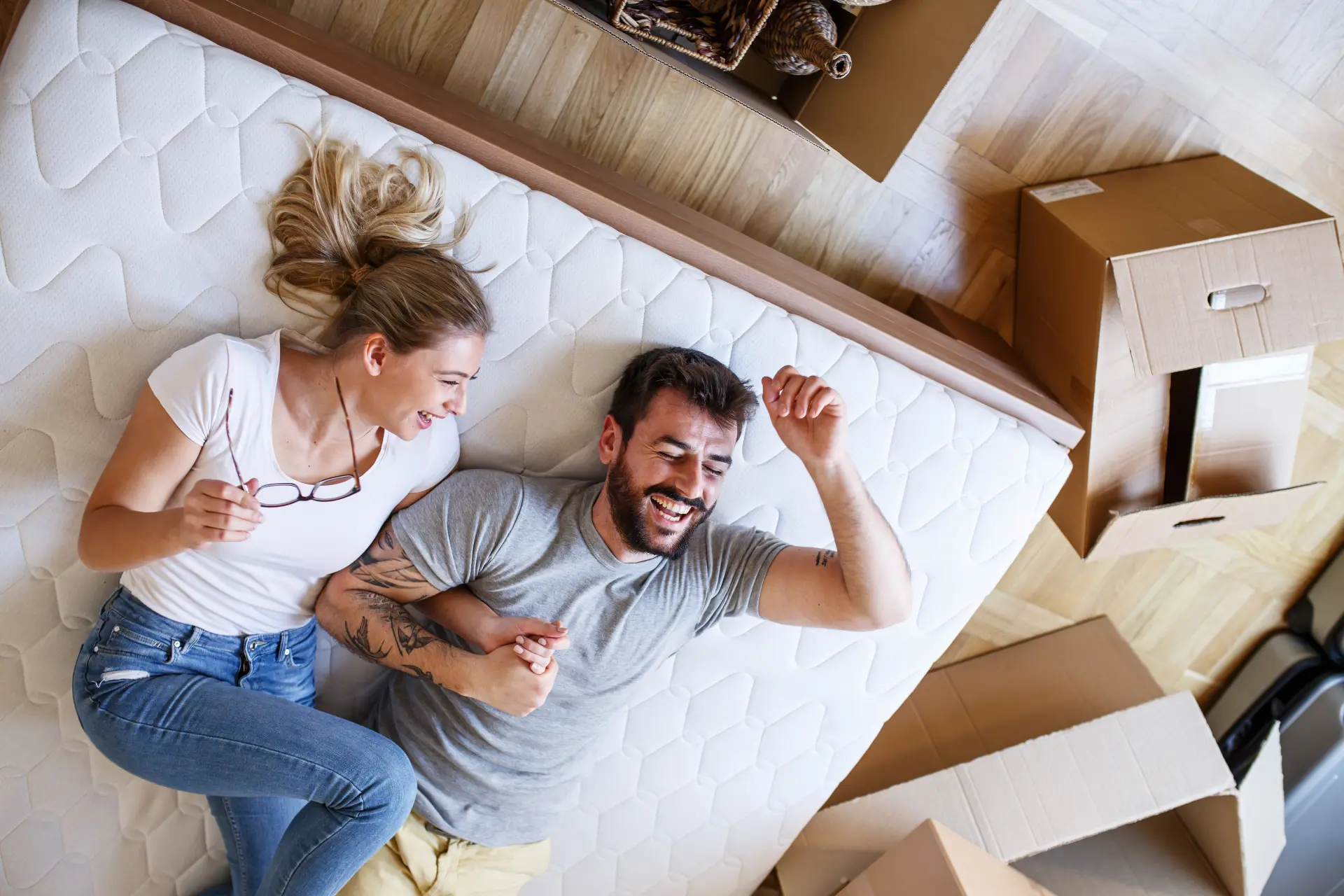 A couple enjoying their new bed at home